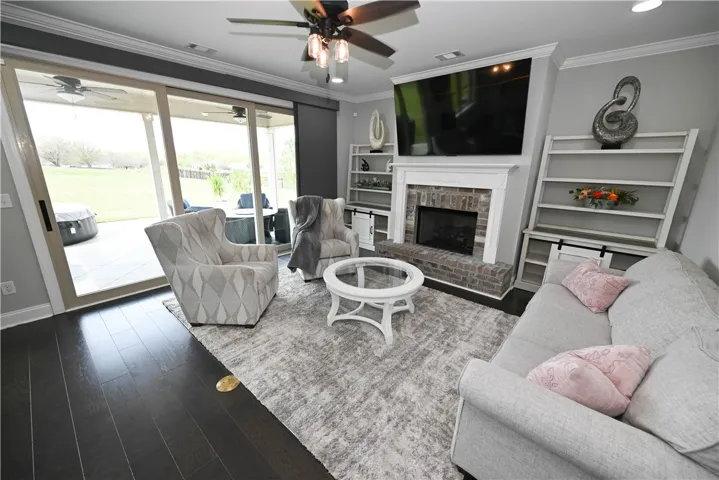 Living room with sliding glass door that opens to the awesome patios!