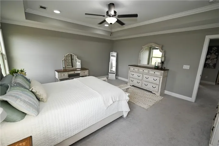 Primary bedroom suite with trey ceiling, recessed lighting, picture windows & private en suite bath