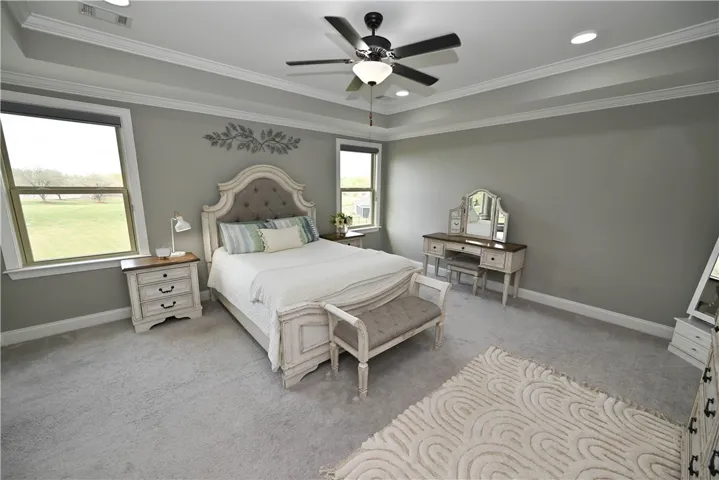 Primary bedroom suite with trey ceiling, recessed lighting, picture windows & private en suite bath