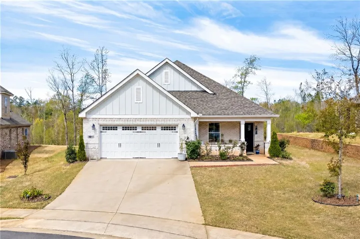 A welcoming facade with a front porch entry and attached garage awaits.