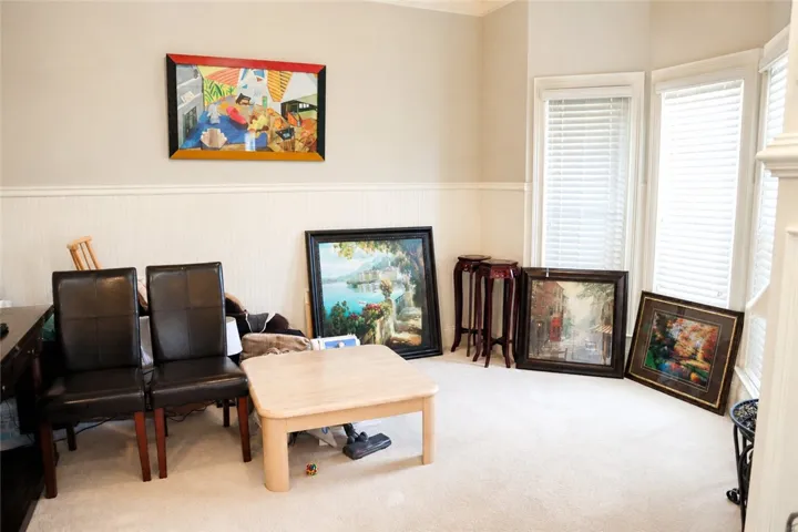 This living room features elegant wainscoting and abundant natural light.