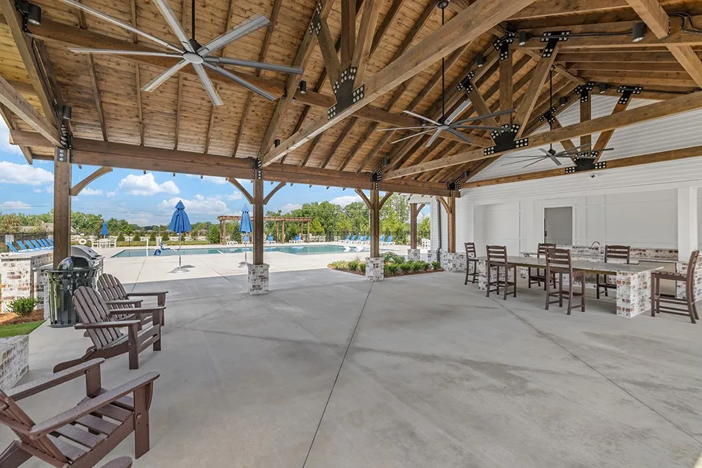 Enjoy outdoor gatherings under the grand timber-framed pavilion next to the sparkling pool.