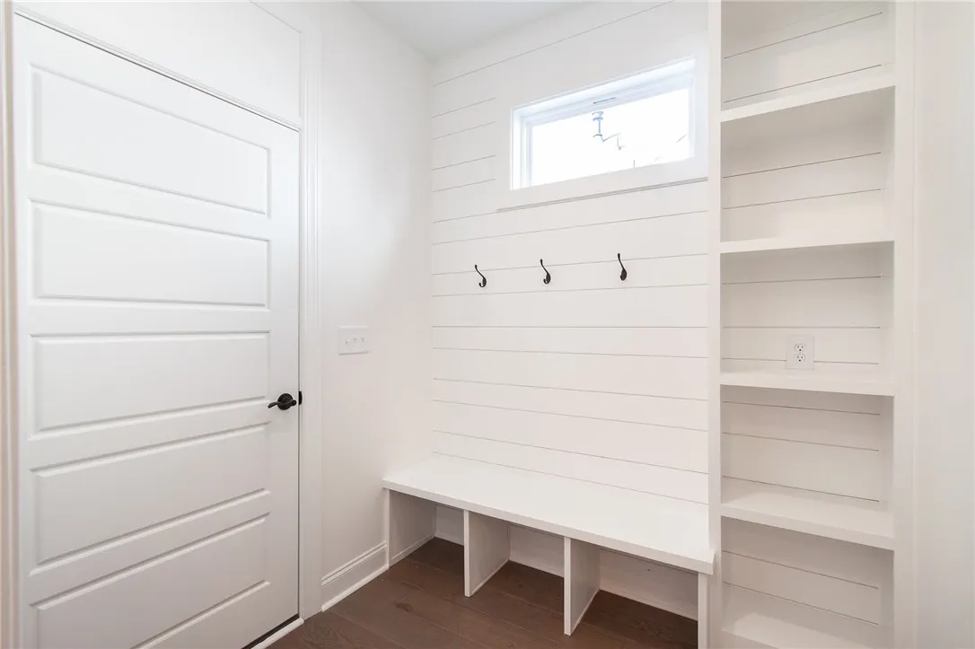 This organized mudroom features practical built-in storage and a convenient seating area. Photos are not of subject property. Photos are of the same floorplan of a completed home.