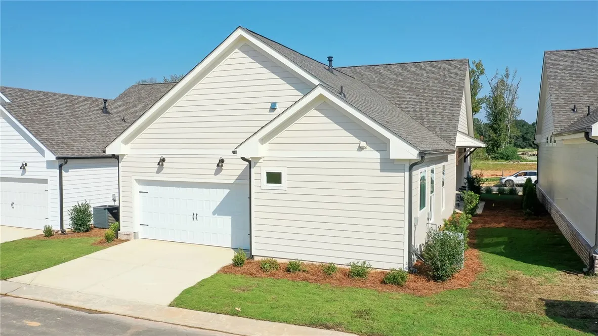 This charming home features a pristine exterior and a convenient  attached garage, ideal for comfortable living.Photos are not of subject property. Photos are of the same floorplan of a completed home.