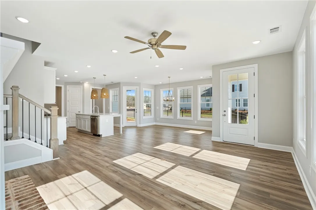 Bright, open-concept living space with abundant natural light and seamless flow. Photos are not of subject property. Photos are of the same floorplan of a completed home.