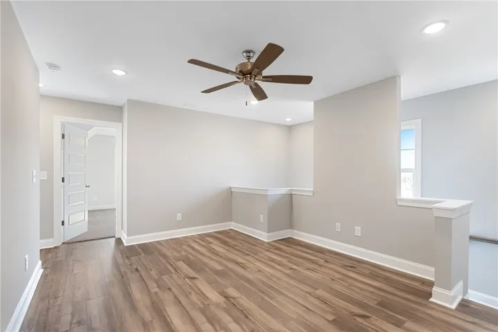 This versatile loft area features durable wood flooring and abundant natural light. Photos are not of subject property. Photos are of the same floorplan of a completed home.