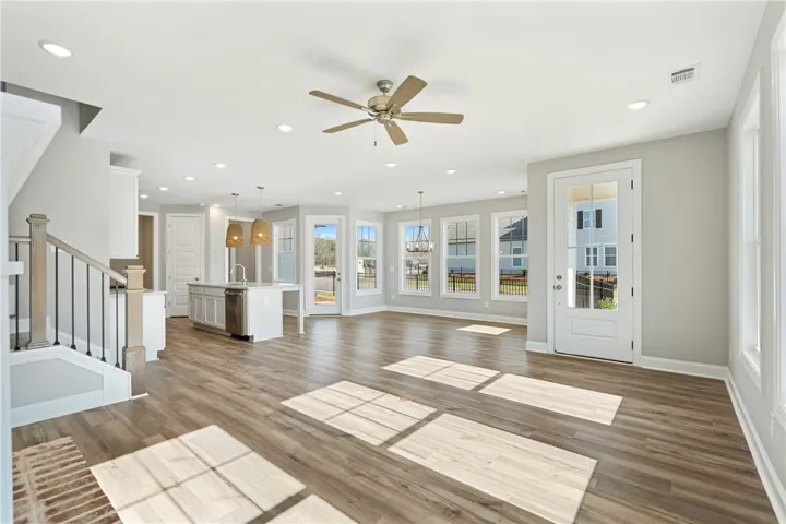 Bright, open-concept living space with abundant natural light and seamless flow. Photos are not of subject property. Photos are of the same floorplan of a completed home.