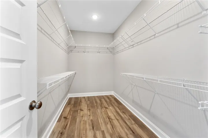 This spacious closet features ample shelving for organized storage, complete with durable flooring. Photos are not of subject property. Photos are of the same floorplan of a completed home.