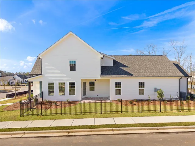This newly constructed residence showcases a crisp white exterior, a durable shingle roof, and a welcoming backyard patio. Photos are not of subject property. Photos are of the same floorplan of a completed home.