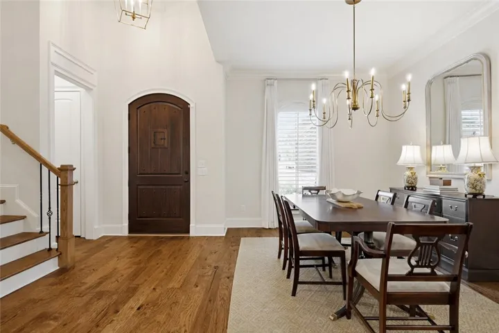 A gorgeous arched wood door exudes charm at the entrance.