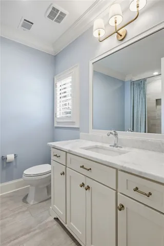 A footed vanity with marble counters.