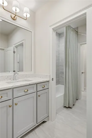 The jack-and-jill bath is highly functional with a spacious vanity servicing each bedroom and a shared wet area.