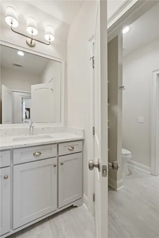 The jack-and-jill bath is highly functional with a spacious vanity servicing each bedroom and a shared wet area.