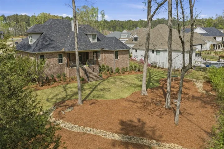 The rear yard is expertly landscaped and also benefits from the beauty of mature trees.