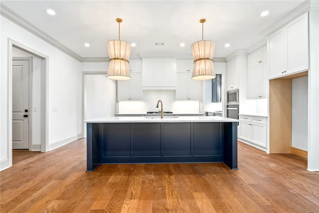 Ceiling-height cabinets topped in quartz are an unexpected upgrade.
