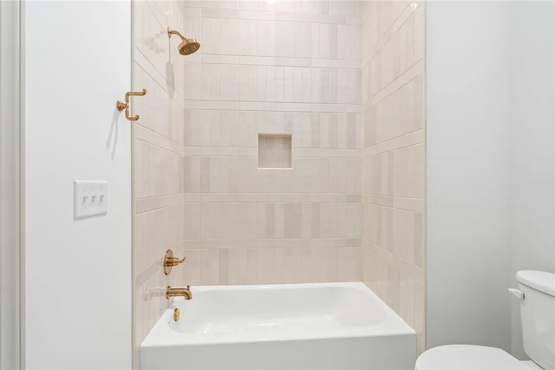 The tile work and creamy cabinets in bath 2 are stunning!