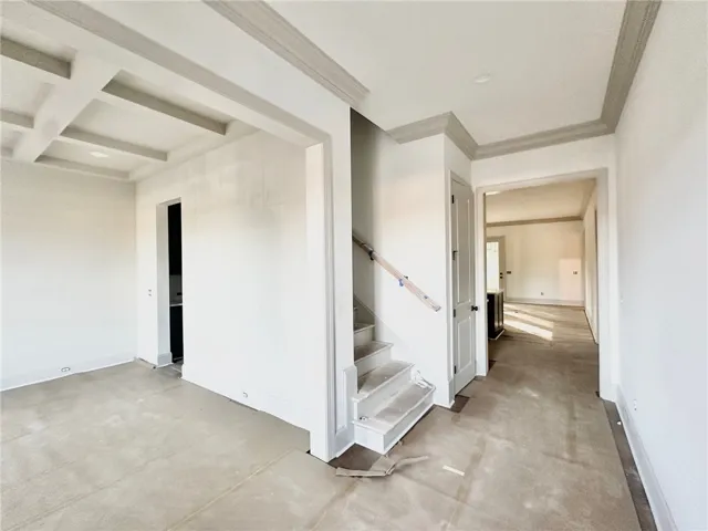 The foyer opens to a formal dining room that carries through to the kitchen via a butler's pantry.
