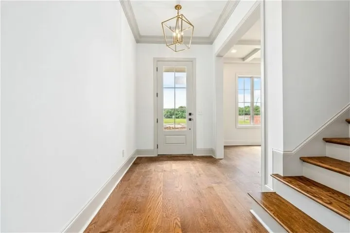 The foyer opens to a formal dining room that carries through to the kitchen via a butler's pantry.