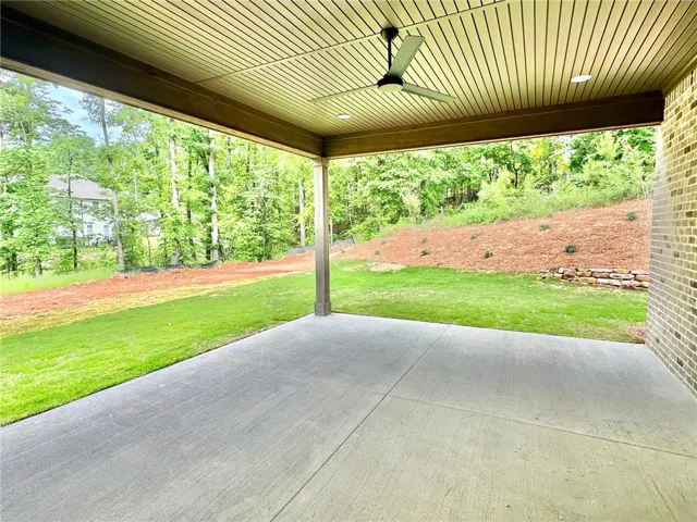 The rear porch is a great spot to enjoy the spacious and private side yard.