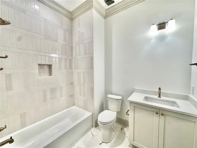 The tile work and creamy cabinets in bath 2 are stunning!