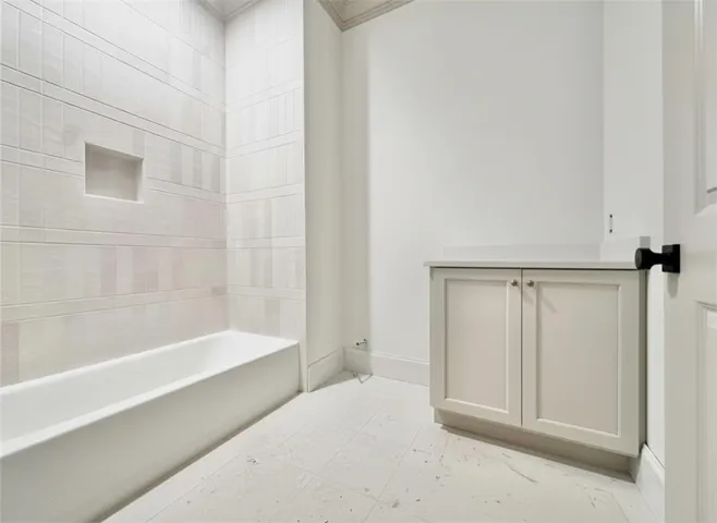 The tile work and creamy cabinets in bath 2 are stunning!