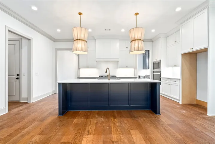 Ceiling-height cabinets topped in quartz are an unexpected upgrade.