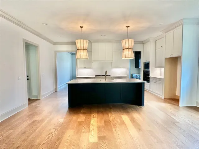 Ceiling-height cabinets topped in quartz are an unexpected upgrade.