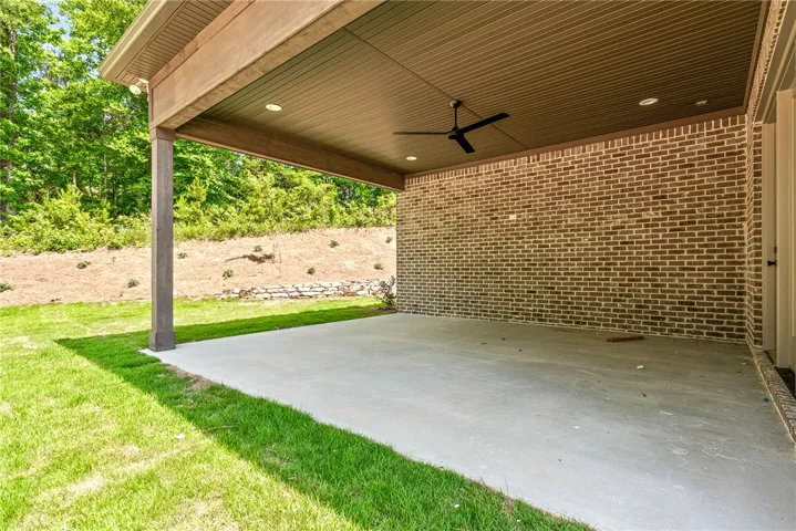 The rear porch is a great spot to enjoy the spacious and private side yard.