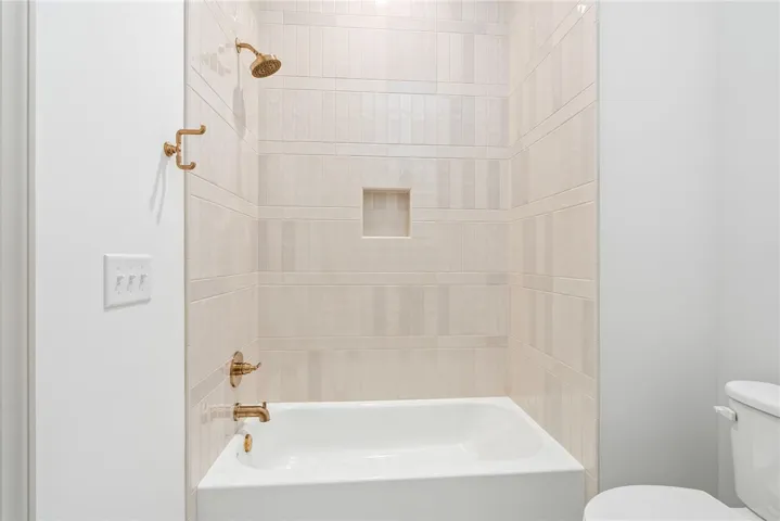 The tile work and creamy cabinets in bath 2 are stunning!