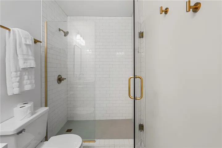 Floor to ceiling tile shower with frameless glass