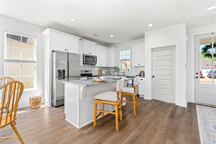 Open concept kitchen with bar seating. Refrigerator to remain.