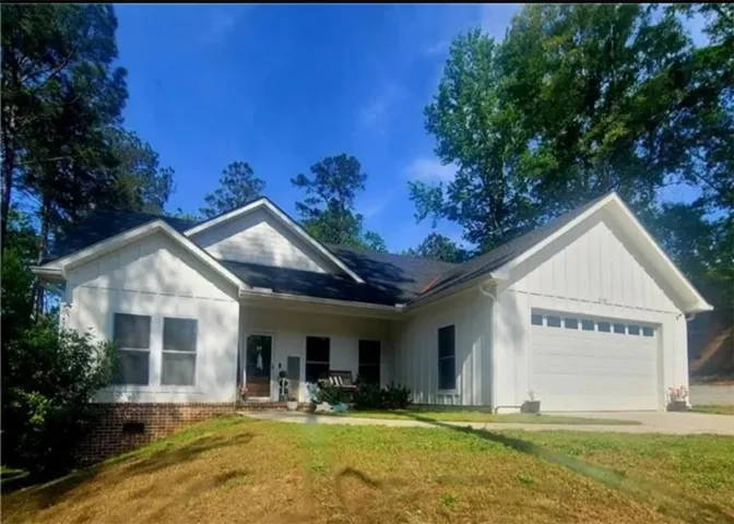 This charming residence features a well-maintained exterior and inviting curb appeal.