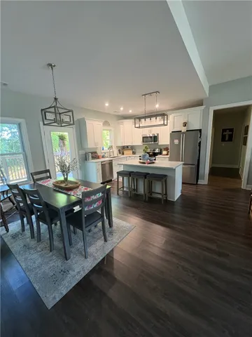 This open-concept kitchen and dining area features modern amenities and rich flooring.