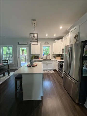 This bright kitchen features modern appliances and a spacious island, ideal for gathering and entertaining.