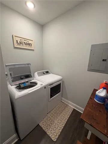 This dedicated laundry area features functional appliances and durable flooring for daily tasks.