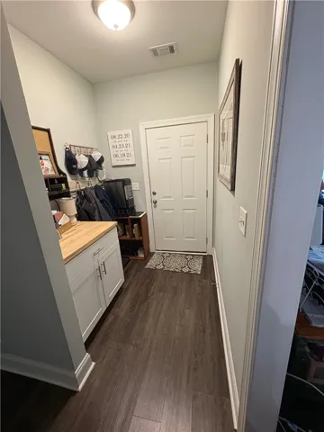 This versatile entryway features durable flooring and convenient cabinetry, perfect for a dynamic lifestyle.
