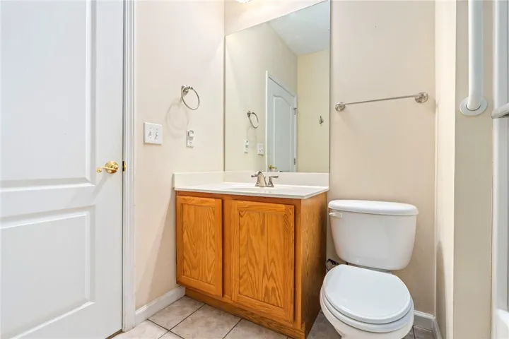 Functional full bathroom with vanity and tile flooring.