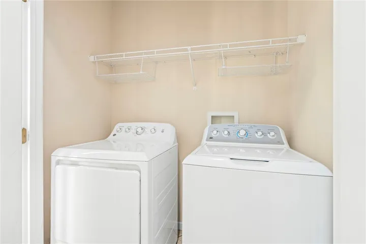 A dedicated utility space with a convenient washer and dryer setup. Washer and dryer included