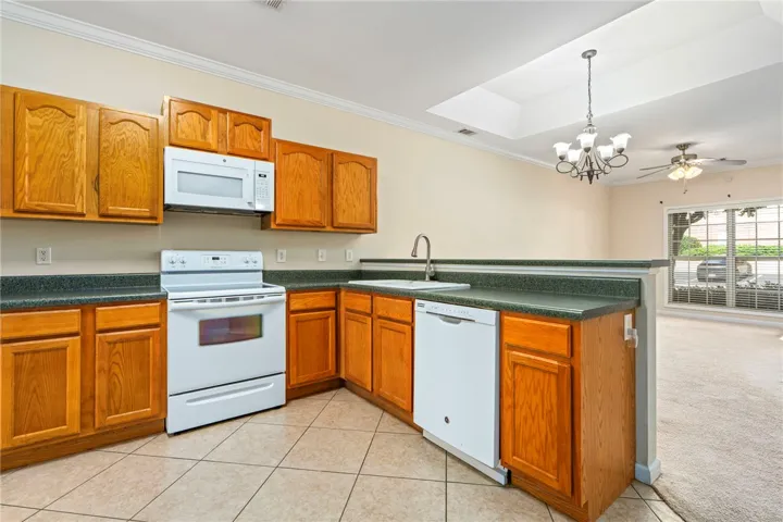 Functional kitchen with ample cabinetry connects seamlessly to the adjoining living room and breakfast room area.
