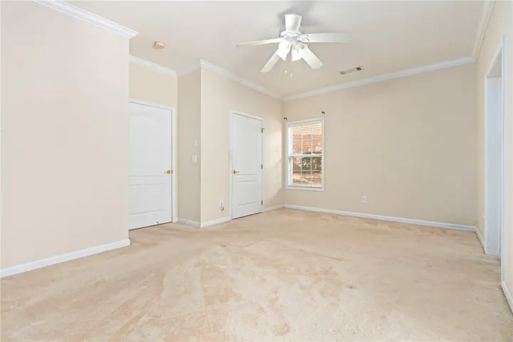 Bedrooms featuring crown molding, ceiling fan, and soft carpet, ready for personalization.