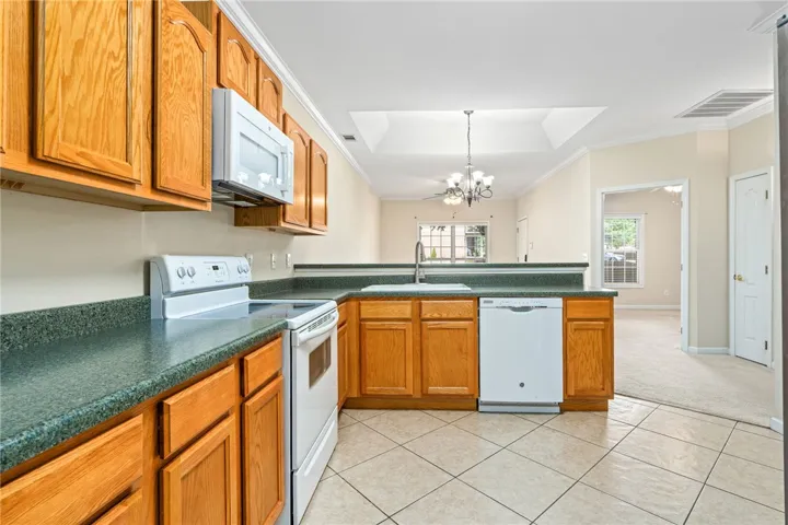 A well-appointed kitchen featuring a functional layout for daily living and entertaining. All appliances remain.  Overlooks dining bar.