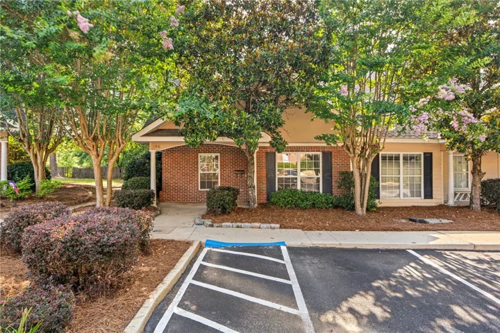A welcoming brick exterior is nestled among mature trees and easy care landscaping which is maintained by COA.