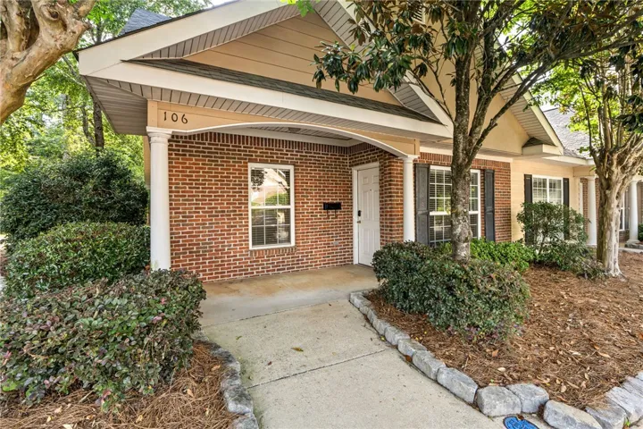A welcoming brick exterior greets visitors with mature landscaping and a well-maintained entry.