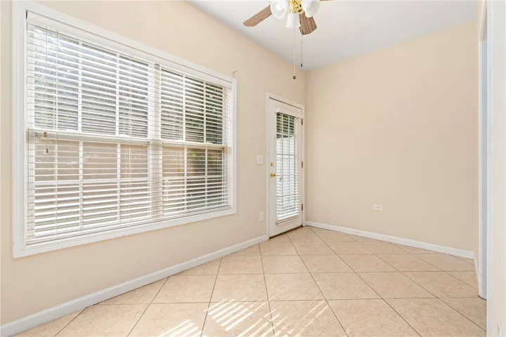 A well-lit flex space area overlooks back year.  Has durable tile flooring and convenient exterior access. Many possible uses -could be used as office, sunroom, bunk room for additional sleeping spaces.