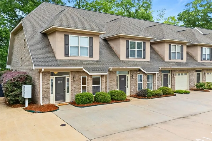 This charming condo features traditional brickwork and inviting dormer windows.