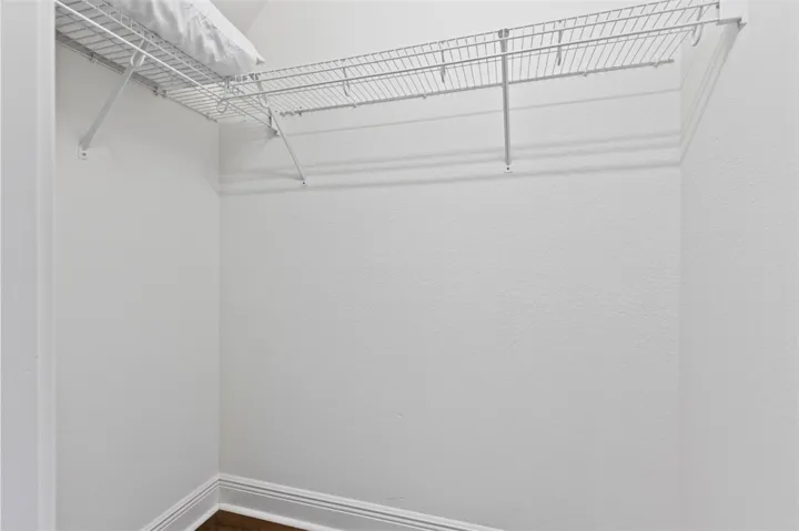 This spacious closet features practical wire shelving, maximizing storage potential for an organized lifestyle.