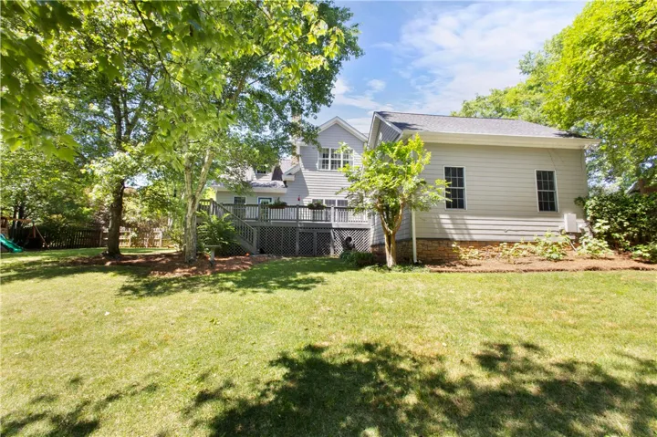 This residence features a spacious private yard and an expansive deck for outdoor enjoyment.