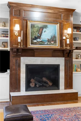 This living space features a beautifully crafted fireplace, offering warmth and a focal point.