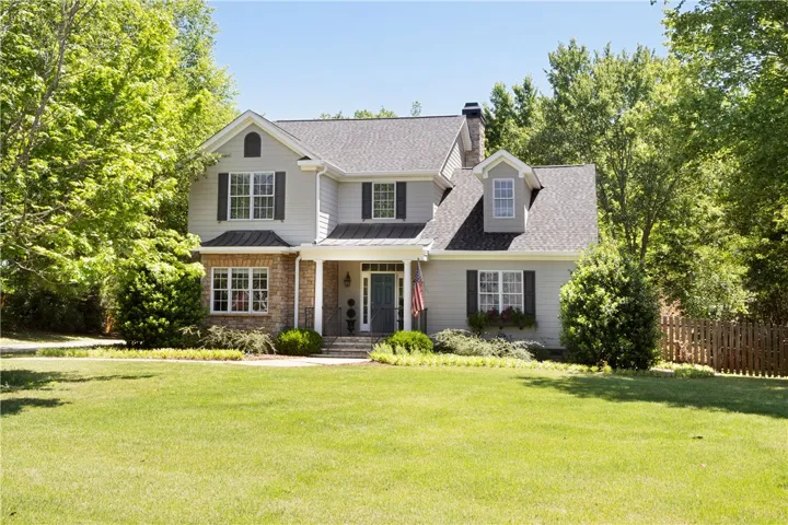 This charming residence features classic architecture and a meticulously landscaped lawn, offering delightful curb appeal.