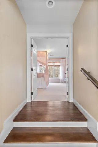 This spacious bedroom offers ample natural light and a serene atmosphere.